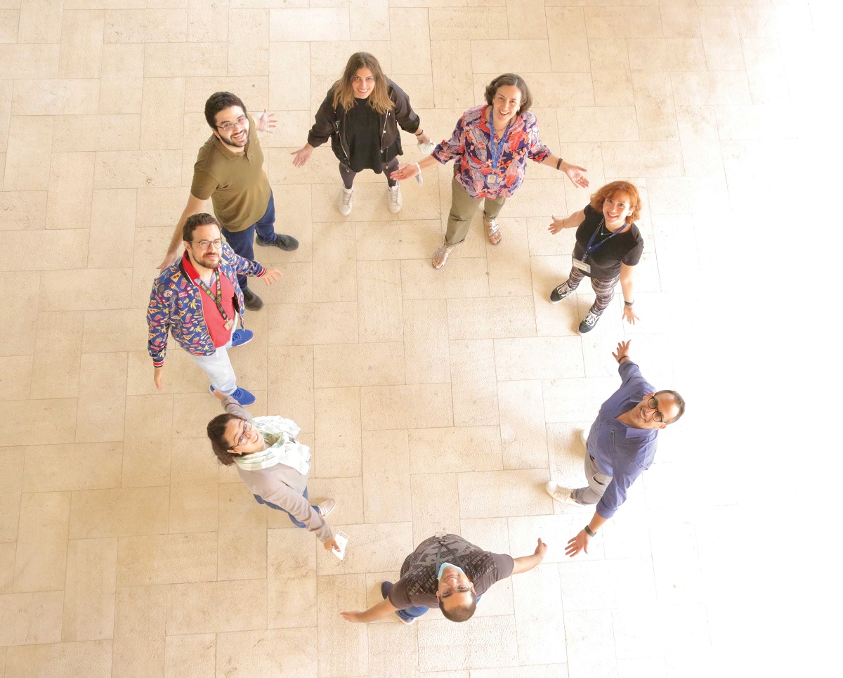 Group of people standing in a circle