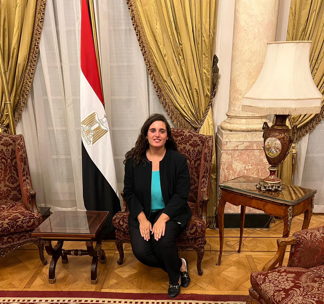 PPAD Student training at the Institute of Diplomatic studies with egypt's flag next to her