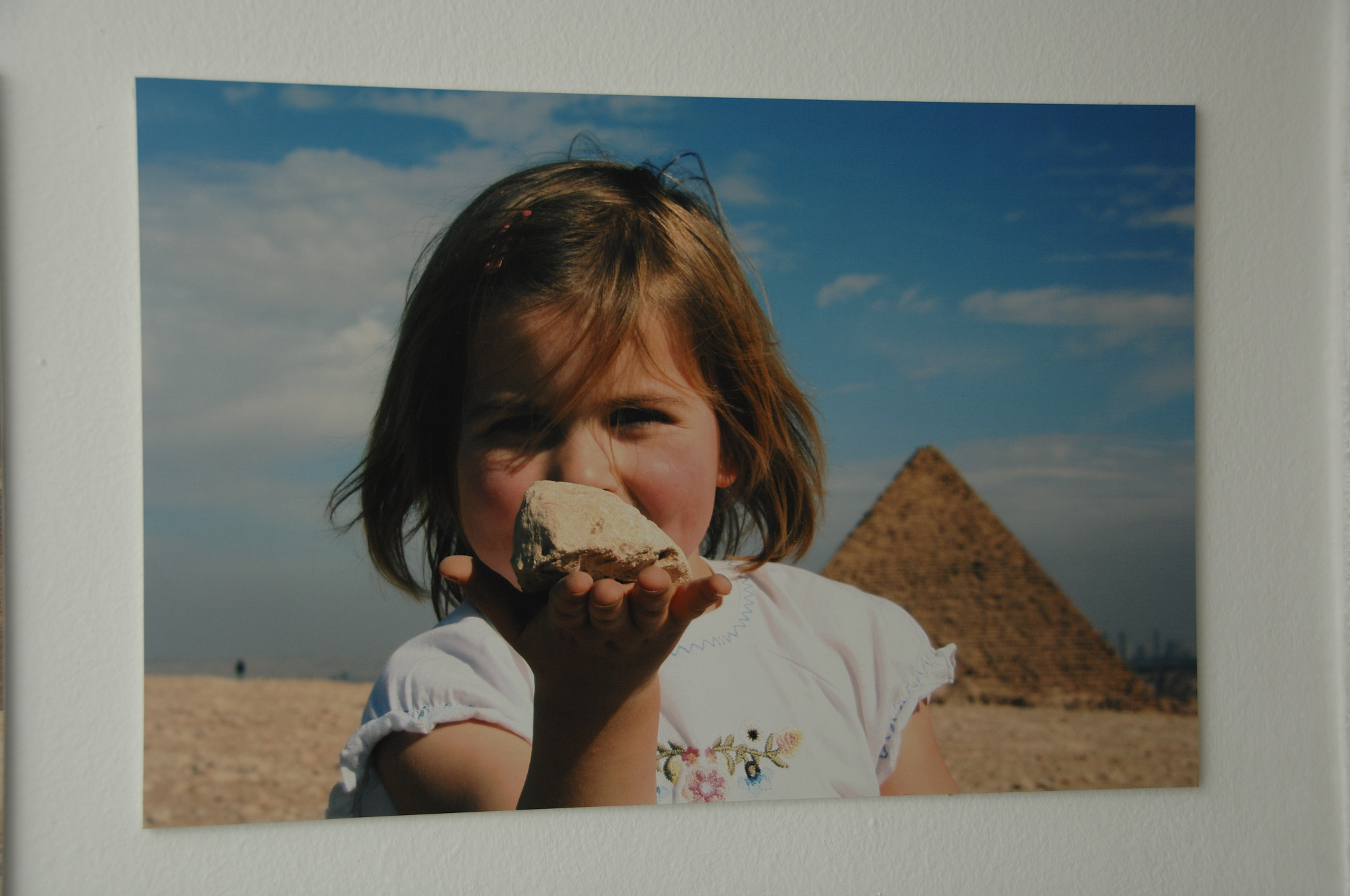 a girl standing in front of the giza pyramids