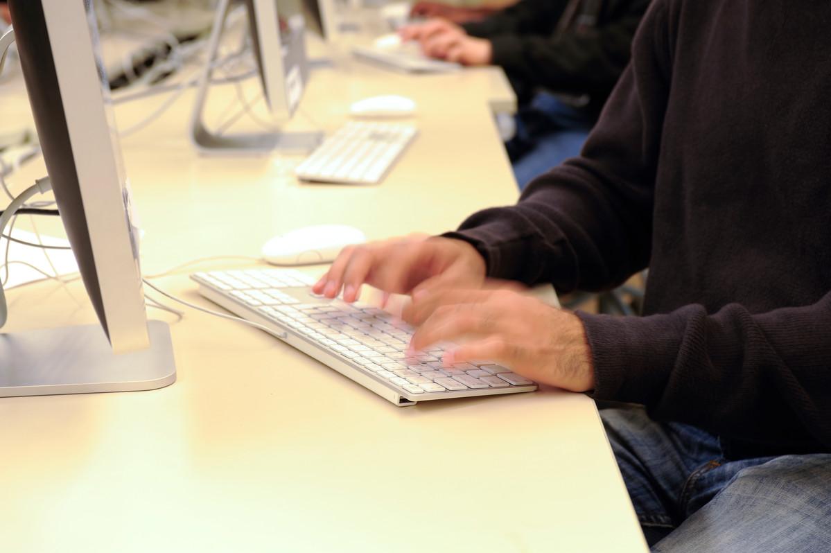image of student hands in computer lab typing