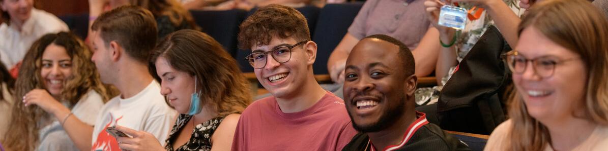 Group of international students in hall smiling 
