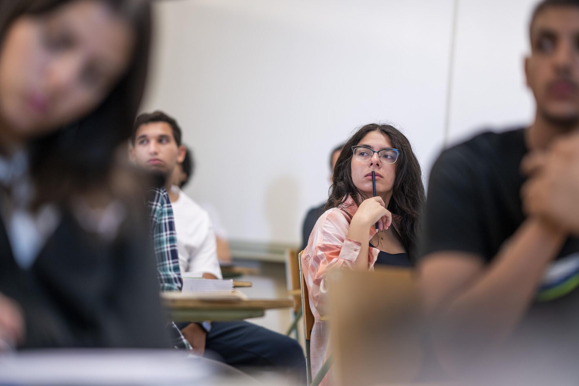 student in a class listening to explanation 