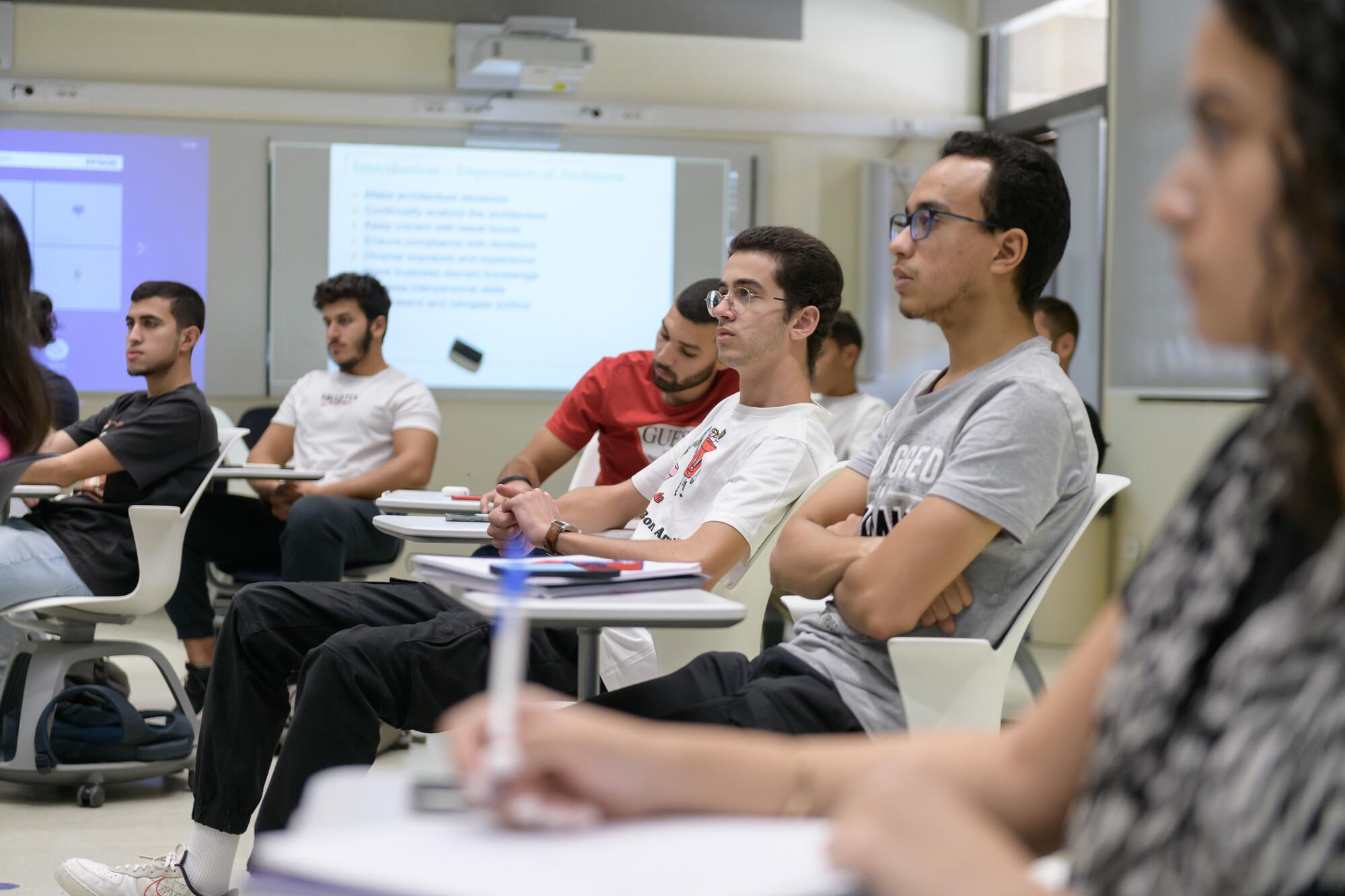 students focusing in classroom taking notes