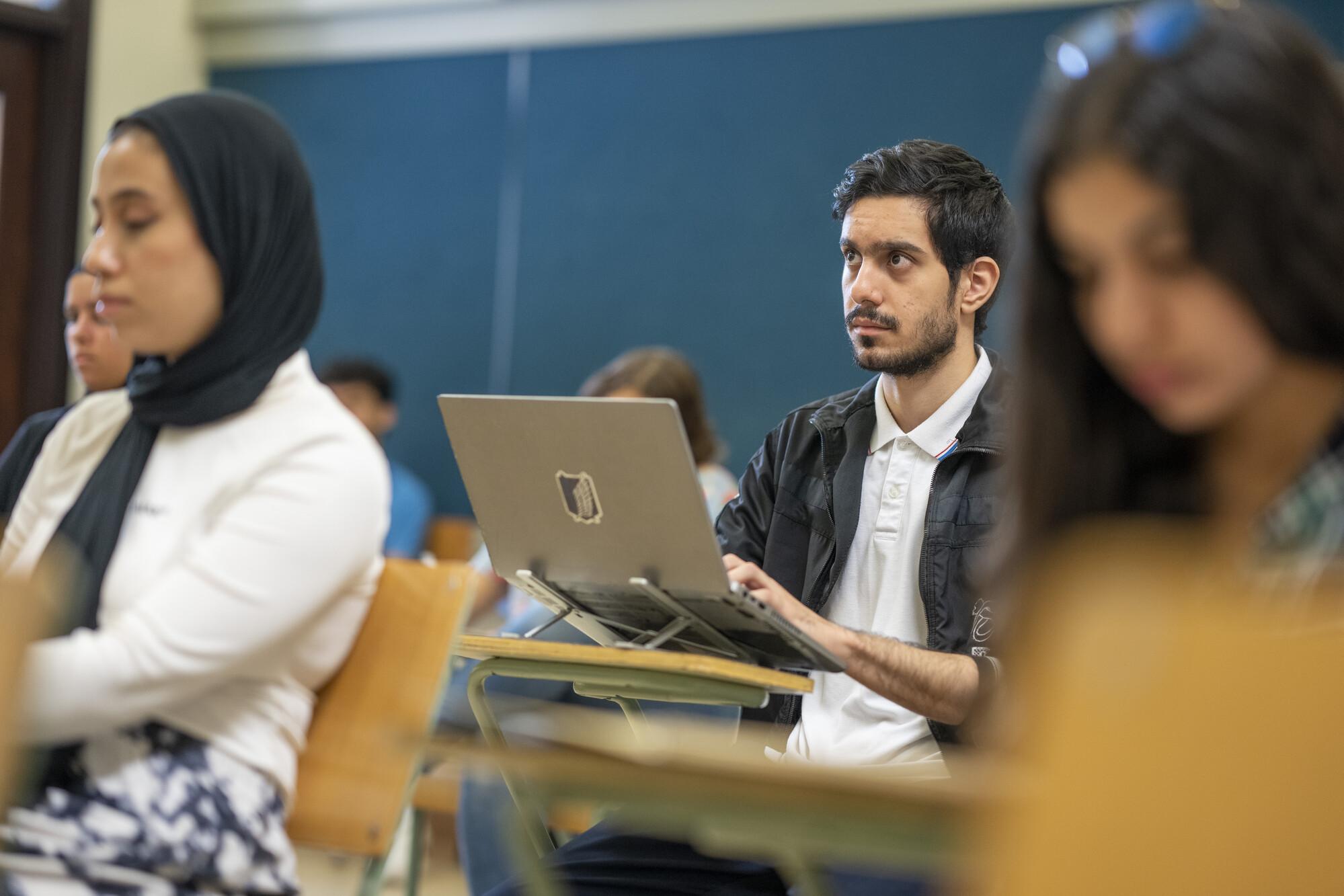 student taking notes in class