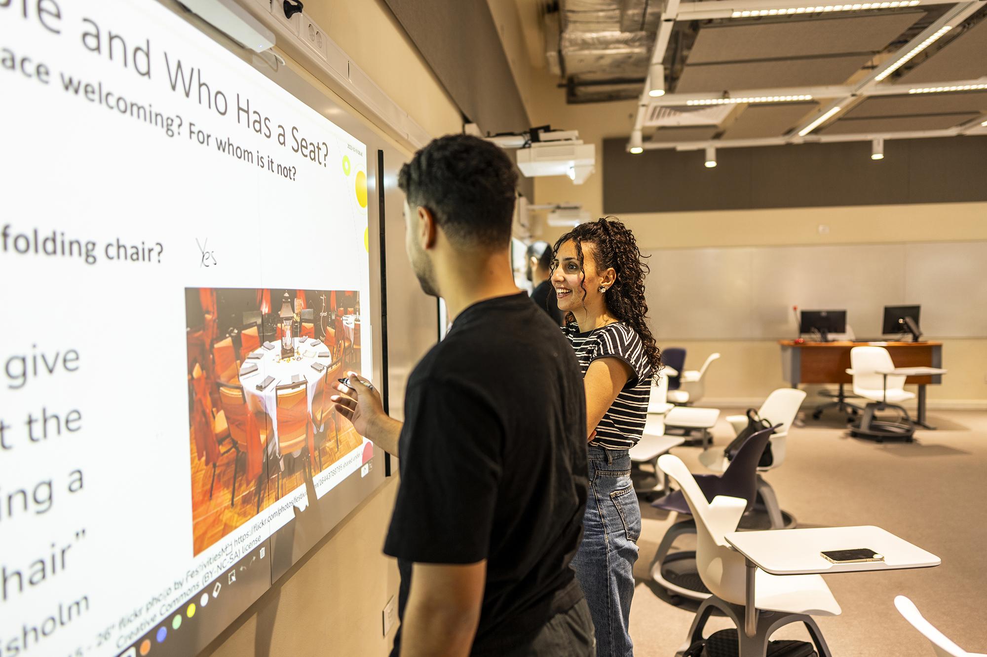 students working with smart board in classroom