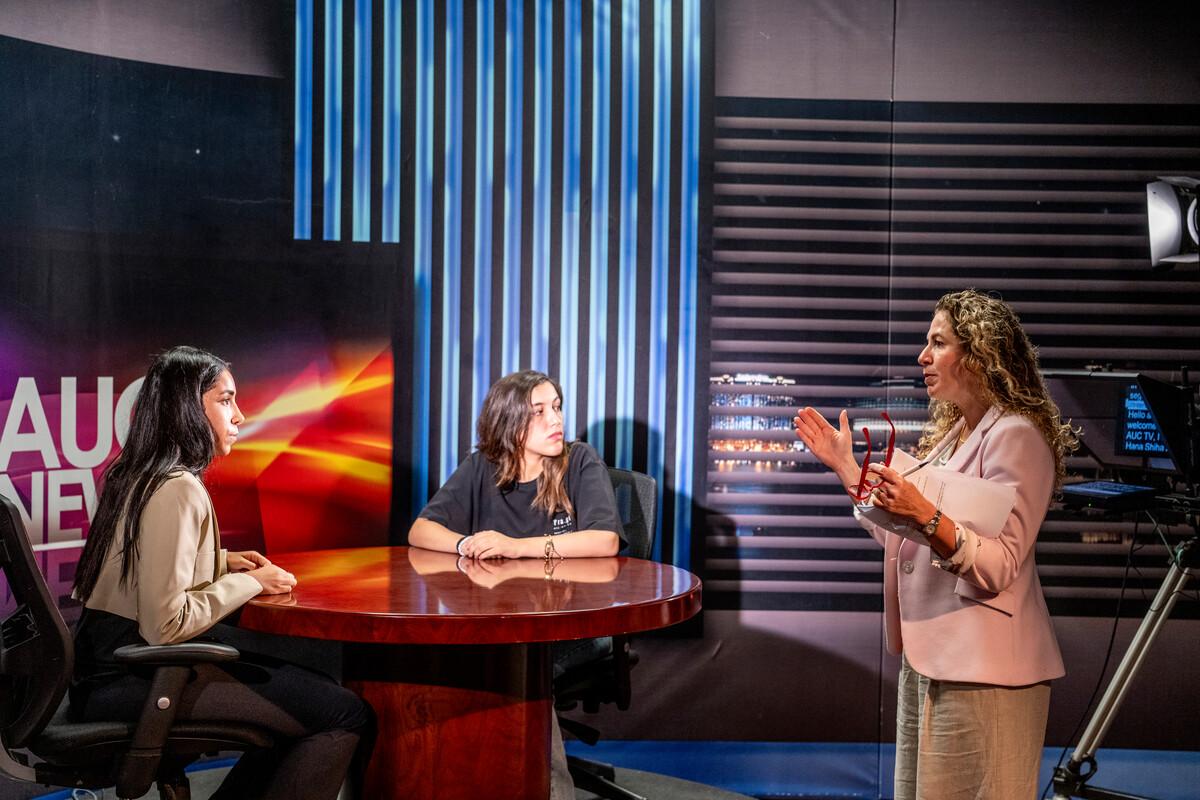 students with professor in tv studio working on AUC TV