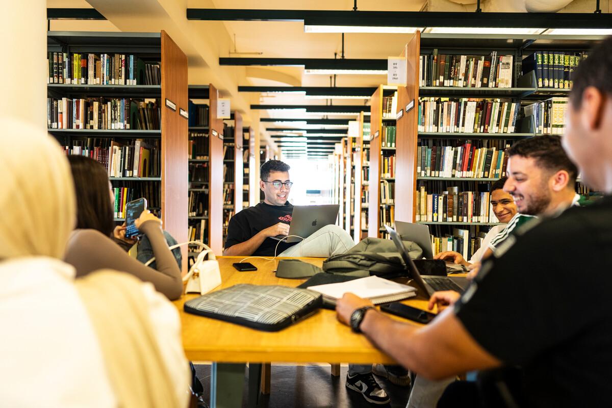 students studying in the library together 