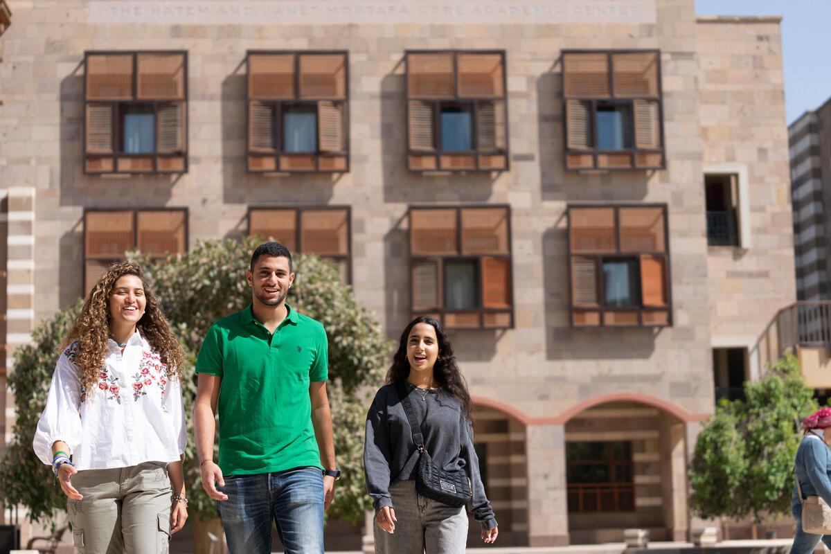 students walking on campus towards another class