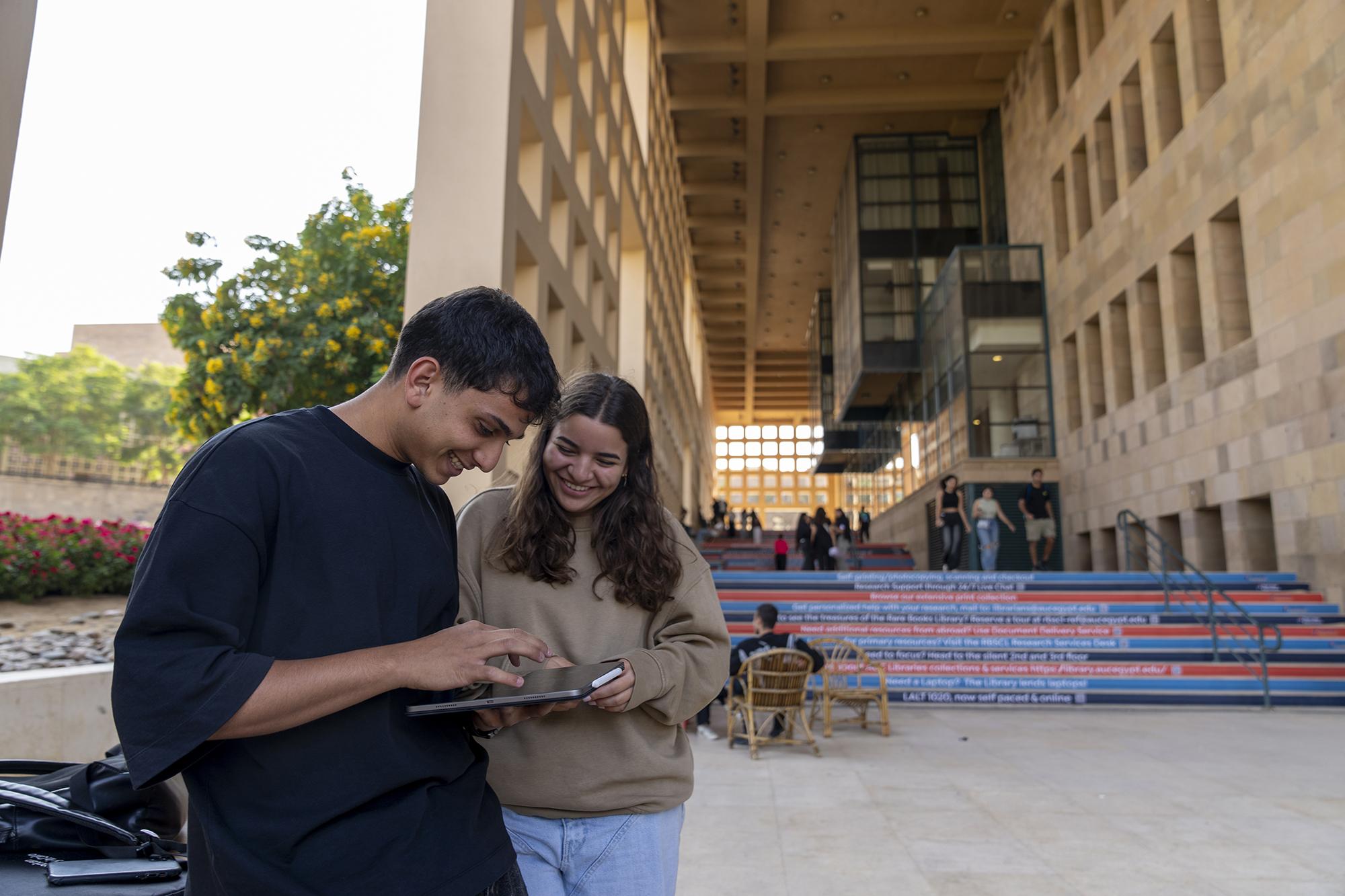 Students in auc working together in the garden
