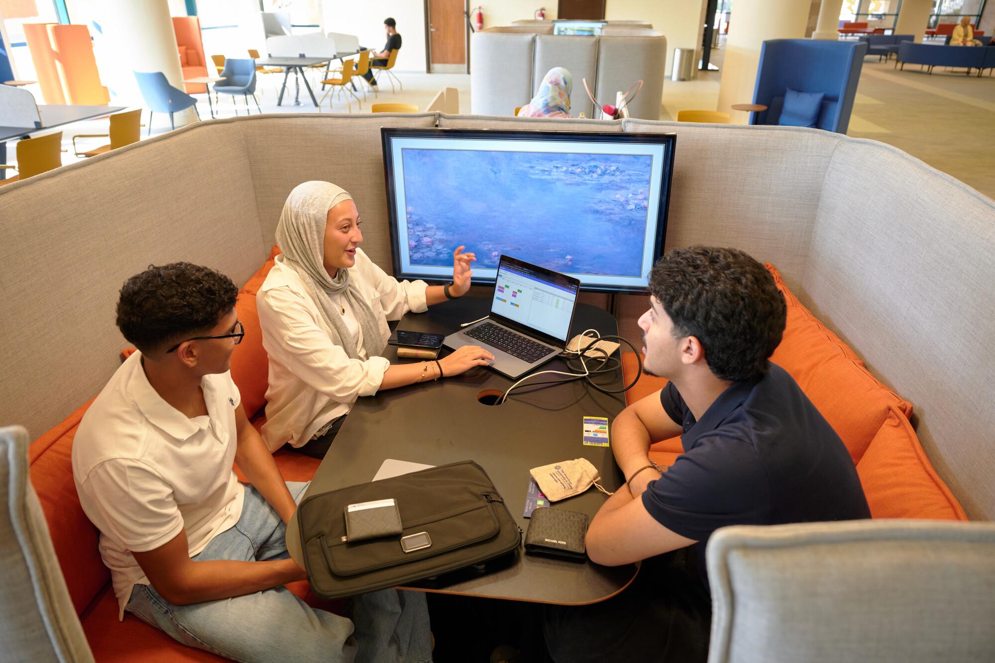 students discussing a project in auc renovated library