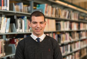 Student standing in a library