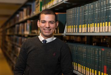 student standing in a library