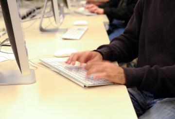 image of student hands in computer lab typing