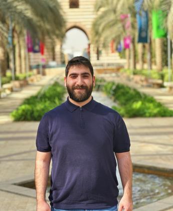 A male is standing in a garden