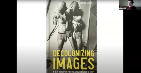A man is standing. Picture is in black and white. Text: Decolonizing Images