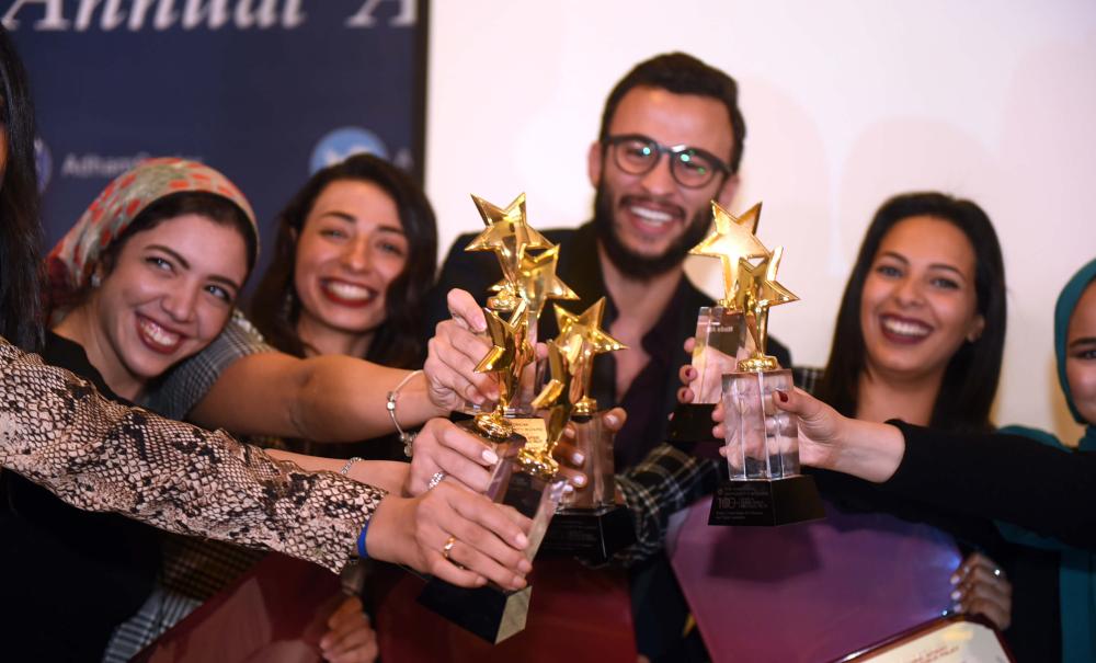 group of male and female students holding trophies