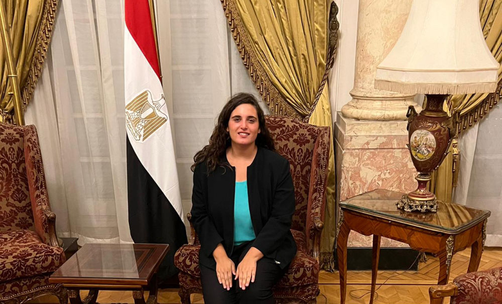 PPAD Student training at the Institute of Diplomatic studies with egypt's flag next to her