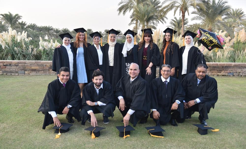 Group of graduates, text reads "Congrats Grads"