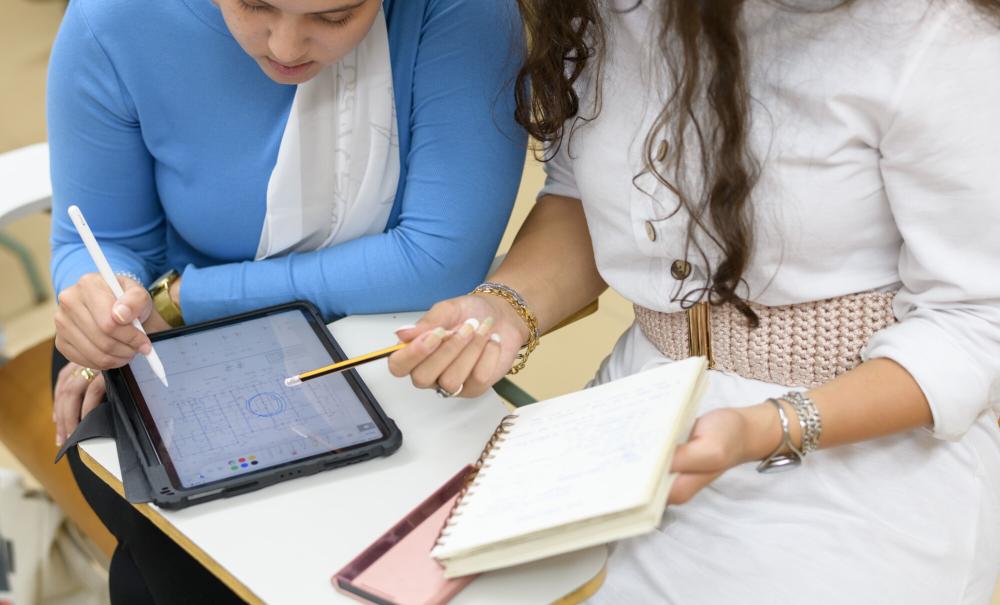 students working together on class assignment writing notes