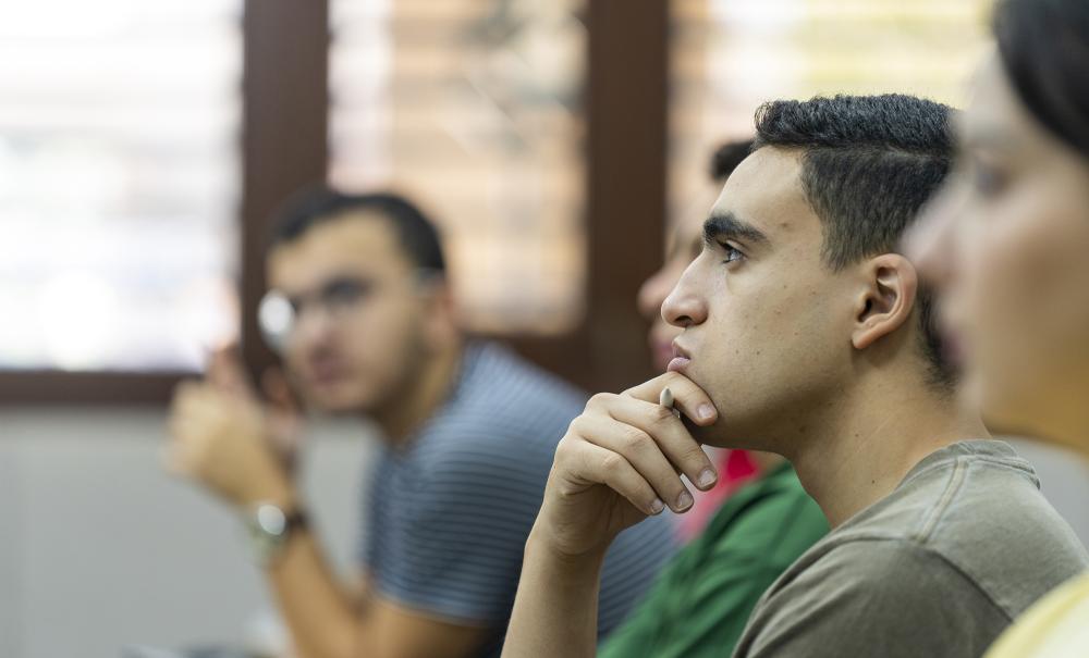 male students in class focusing on lecture