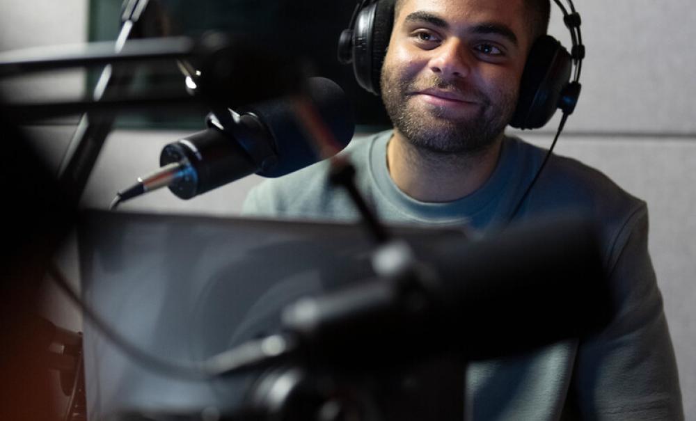 student in a podcast studio recording session