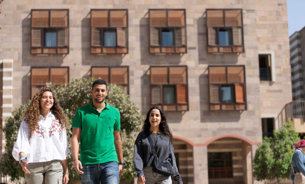 students walking on campus towards another class