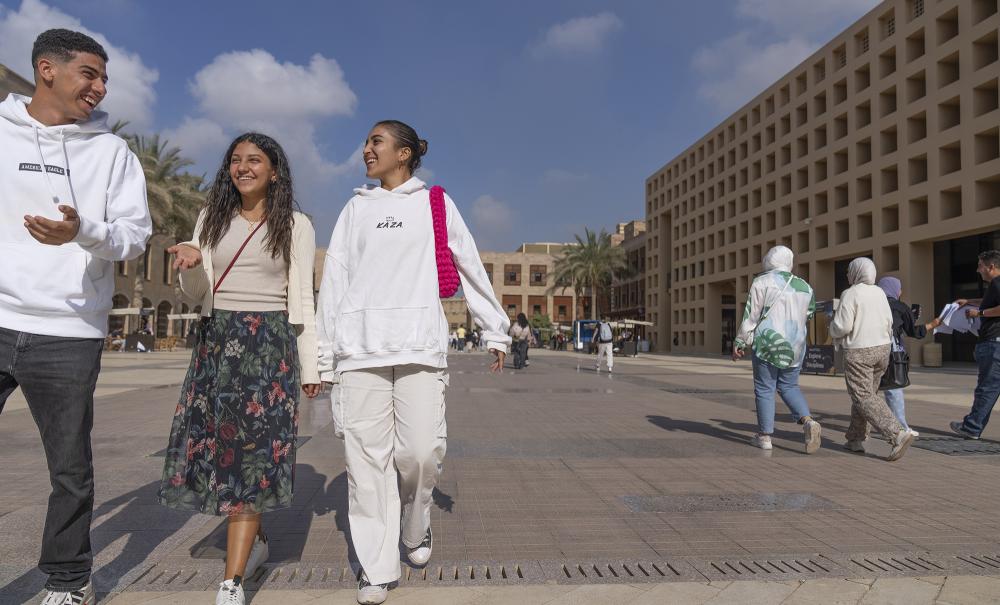 students walking to class in the plaza