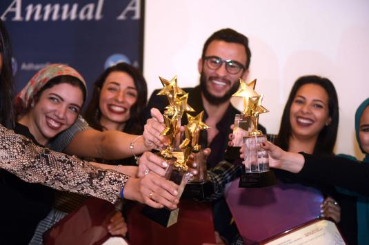 group of male and female students holding trophies