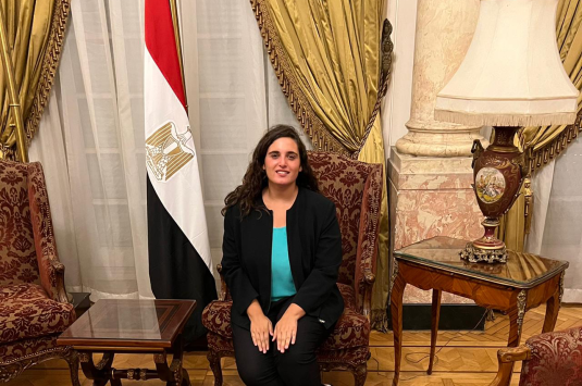 PPAD Student training at the Institute of Diplomatic studies with egypt's flag next to her