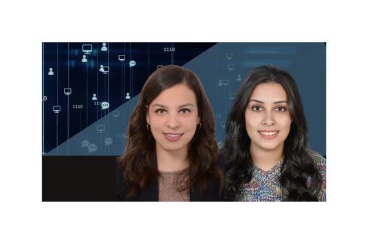 A photo of Laila Abbas and Menna Elhosary in front of a blue screen showing social media icons (follower heads, chat boxes)