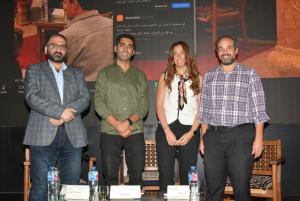 group of attendees in a conference taking a photo on the panel