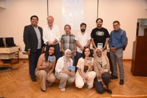 Group of students taking photos with thier professors 