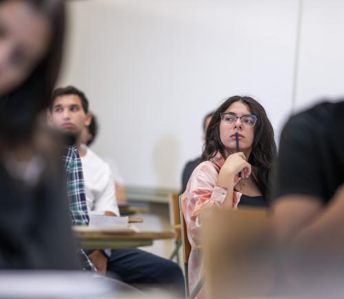 student in a class listening to explanation 