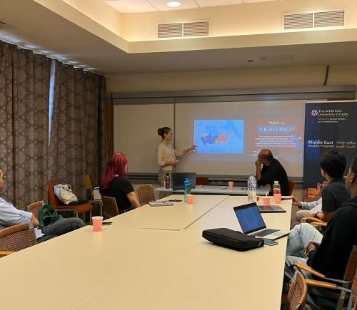 Student presenting infront of other students and explaining her project