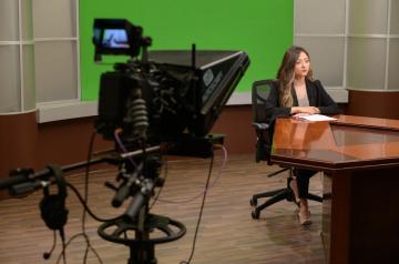 studio on camera presenting news