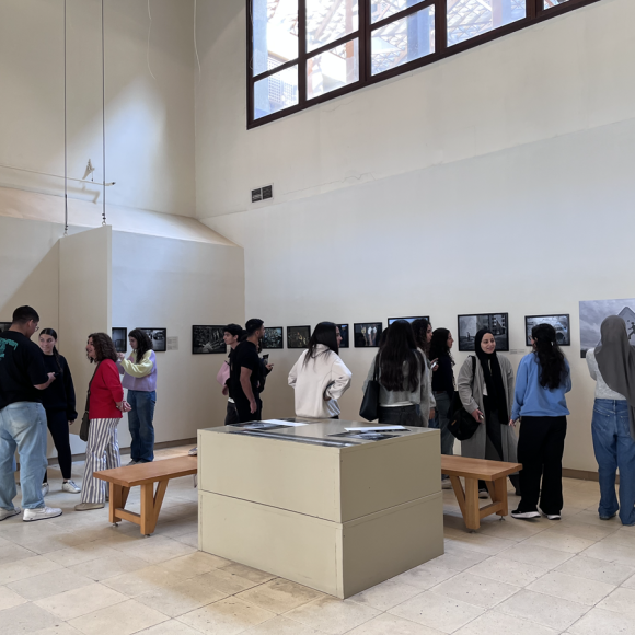 People looking at photographs displayed at an exhibition