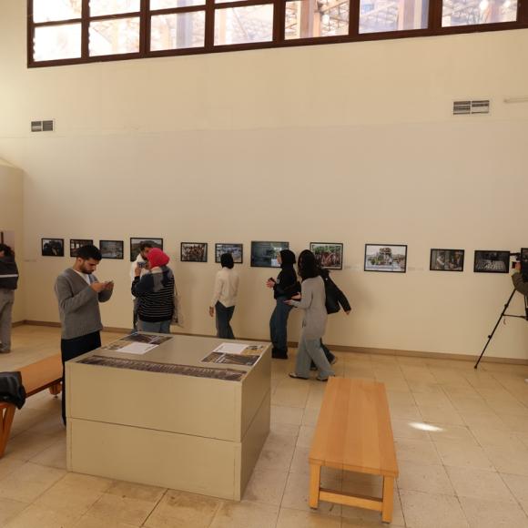 People looking at photographs displayed at an exhibition