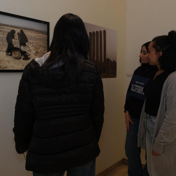 People looking at photographs displayed at an exhibition