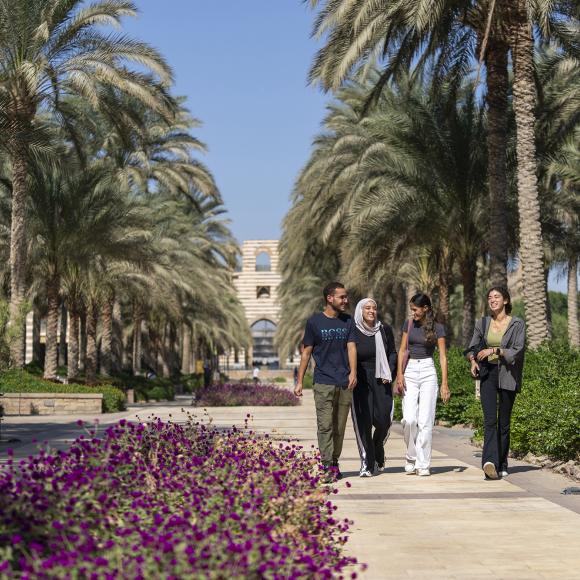 group of students walking in the auc gardens