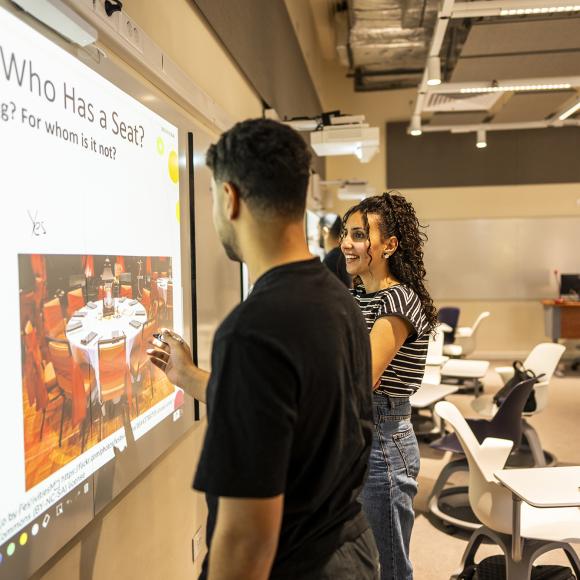 students working on smart boards